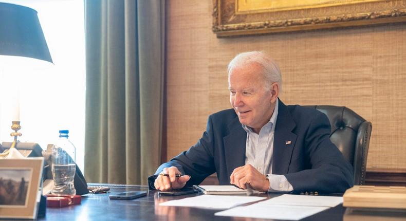 President Joe Biden was photographed sitting at his desk in the White House residence without wearing a mask after he tested positive for COVID-19 on Thursday.