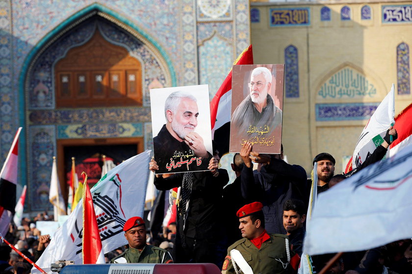 Kataib Hezbollah Iraqi militia hold the picture of the Iranian Major-General Qassem Soleimani, as th