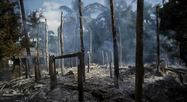 Smouldering debris of burned houses in Warpait village, a Muslim village in Myanmar's Rakhine State on October 14, 2016