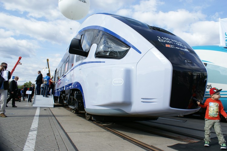Polski Dart został skrócony o trzy człony, żeby w ogóle zmieścić się na torach wystawienniczych. Pociąg budzi duże zainteresowanie. Pesa zamontowała w środku sporo efektownych dodatków, których nie ma w składach kursujących po polskich torach, a pasowałyby do wnętrza samolotu pasażerskiego. Np. interaktywny stół „smart travel” z ekranem dotykowym, który umożliwia m.in. oglądanie filmów i granie w gry, ale też np. zamówienie posiłku w przedziale barowym (gdzie można zapłacić w technologii NFC). <br><br>

Dart miał być „polskim Pendolino”. Z powodu szalonego tempa dostaw 20 składów prototypowej konstrukcji ten kontrakt dla PKP Intercity o mało co nie wywrócił firmy. Pesa przetrwała, bo rząd zgodził się na zmianę warunków odbiorów, ale kwestia kar umownych dla PKP Intercity jest wciąż nierozstrzygnięta. <br><br>

Na zdj. Pociągi Dart od Pesy w czasie targów kolejowych Innotrans w Berlinie. Fot. Konrad Majszyk