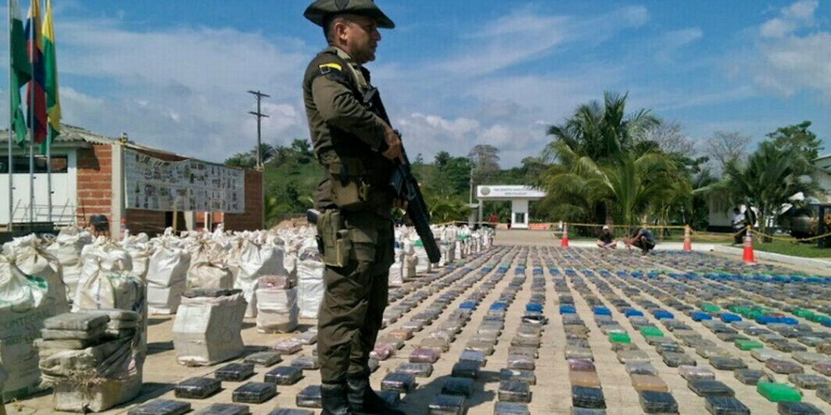 A Colombian police officer guards 8 tons of seized cocaine in Turbo, Antioquia department, in northwestern Colombia, on May 15, 2016.