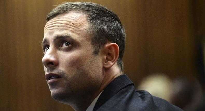 Blade Runner Oscar Pistorius sits in the dock in the North Gauteng High Court in Pretoria, in this file picture taken March 4, 2014.    REUTERS/Antoine de Ras/Pool /Files