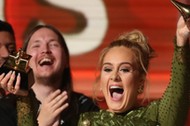 Adele breaks the Grammy for Record of the Year for Hello after having it presented to her at the 59th Annual Grammy Awards in Los Angeles