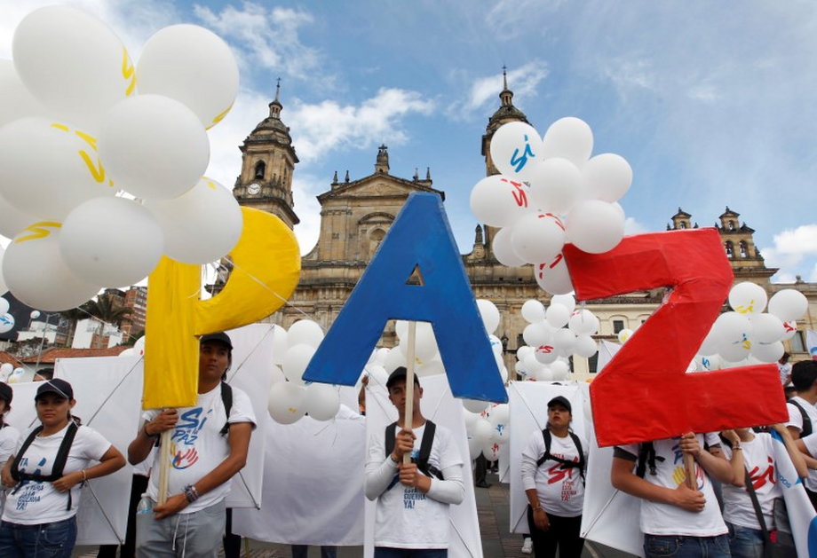 People form the word "Peace" with letters at the Bolivar square outside the cathedral in Bogota, Colombia, September 26, 2016.