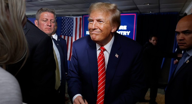 Former President Donald Trump grins as he signs an autograph after a rally in New Hampshire a day before winning the state's primary.Chip Somodevilla/Getty Images