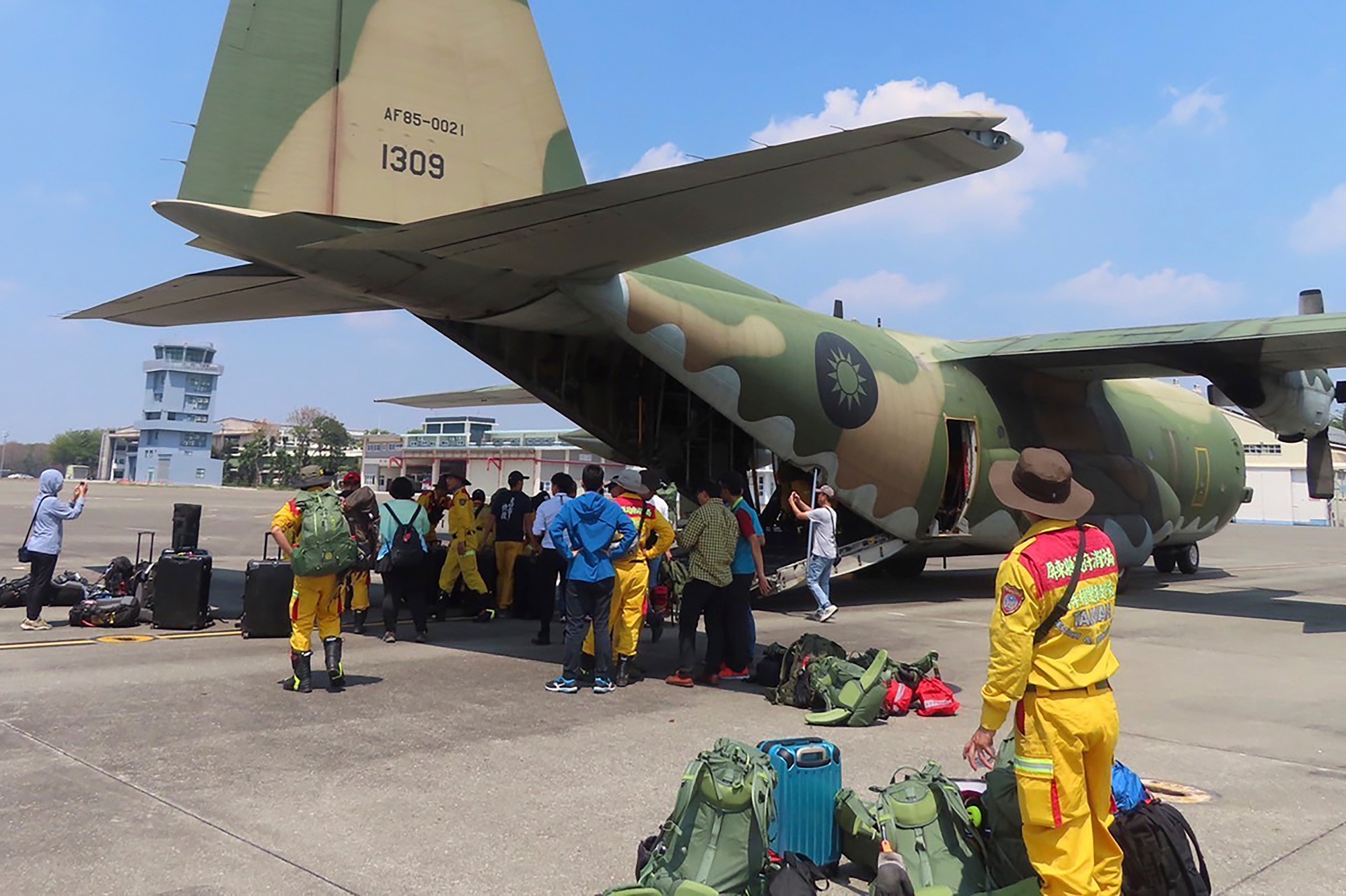 Členovia pátracieho a záchranného tímu sa pripravujú na nasadnutie do lietadla C-130 taiwanských vzdušných síl z vojenskej leteckej základne Pching-tung do oblasti Chua-lien na Taiwane.
