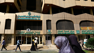 People walk past the Faisal Islamic Bank in Khartoum, Sudan January 12, 2016.