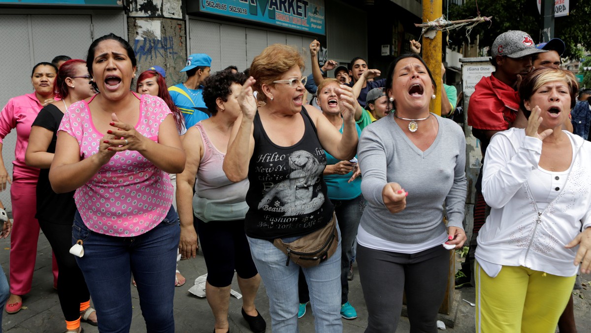 People shout at Venezuelan National Guards during riots for food in Caracas