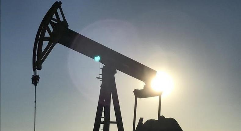 An oil rig drilling a well at sunrise near Midland, Texas