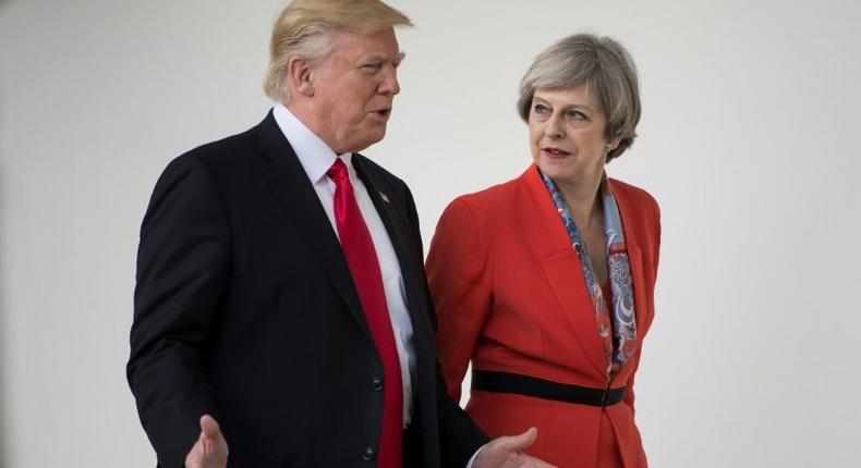 US President Donald Trump and British Prime Minister Theresa May walk to a press conference at the White House on January 27, 2017