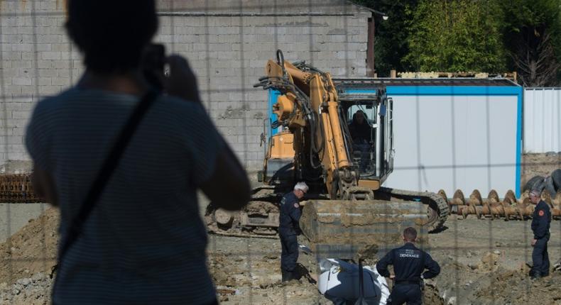 Some 2,300 residents were evacuated as the experts dug a hole around the bomb before cutting it up and taking it away to be destroyed