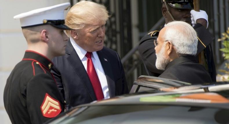 US President Donald Trump (C) and Indian Prime Minister Narendra Modi (R), shown at the White House, are seeking to solidify the relationship between their countries