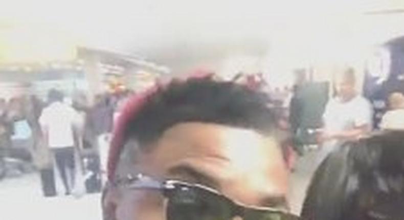 Oritsefemi and his wife at the airport