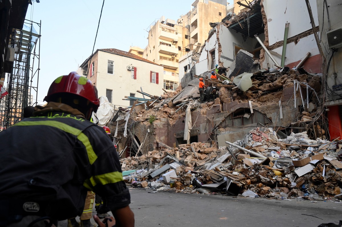 Rescuers look for a survivor under the rubble