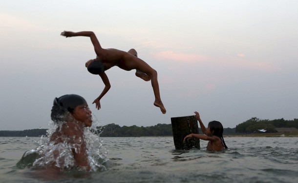 Indigenous people from the Kamayura tribe take a bath in Ipavu lake at the Xingu national park in Ma