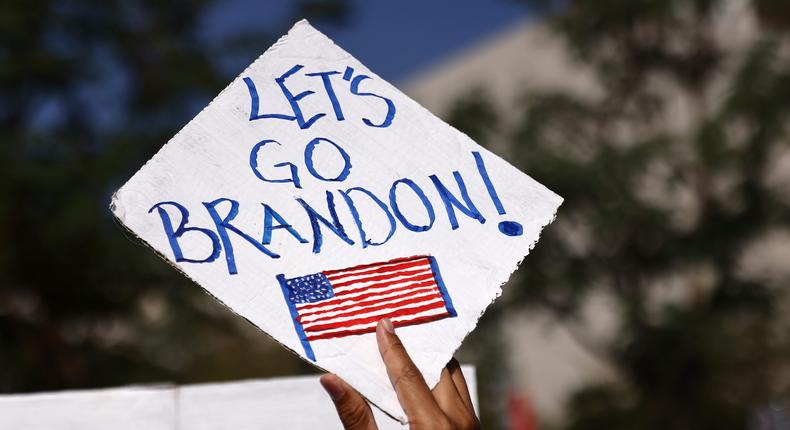 A protestor holds a 'Let's Go Brandon!' sign at a rally in Los Angeles in November 2021.