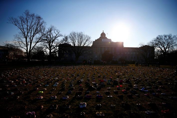 Activists install 7000 shoes on the lawn in front of the U.S. Capitol on Capitol Hill in Washington