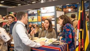 Tourists learning about Uganda at the stand 