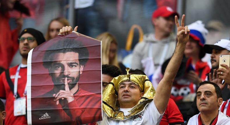 TOPSHOT - A Egypt's fan holds a poster showing Egypt's forward Mohamed Salah before the Russia 2018 World Cup Group A football match between Russia and Egypt at the Saint Petersburg Stadium in Saint Petersburg on June 19, 2018. (Photo by Olga MALTSEVA / AFP via Getty Images)
