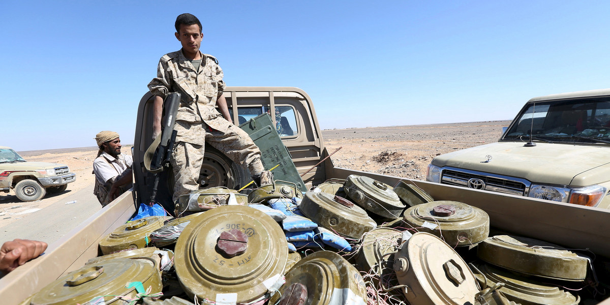 A Yemeni government soldier stands on a truck transporting land mines left by the Houthi rebels in al-Jadaan area, in the country's central province of Marib, December 21, 2015.