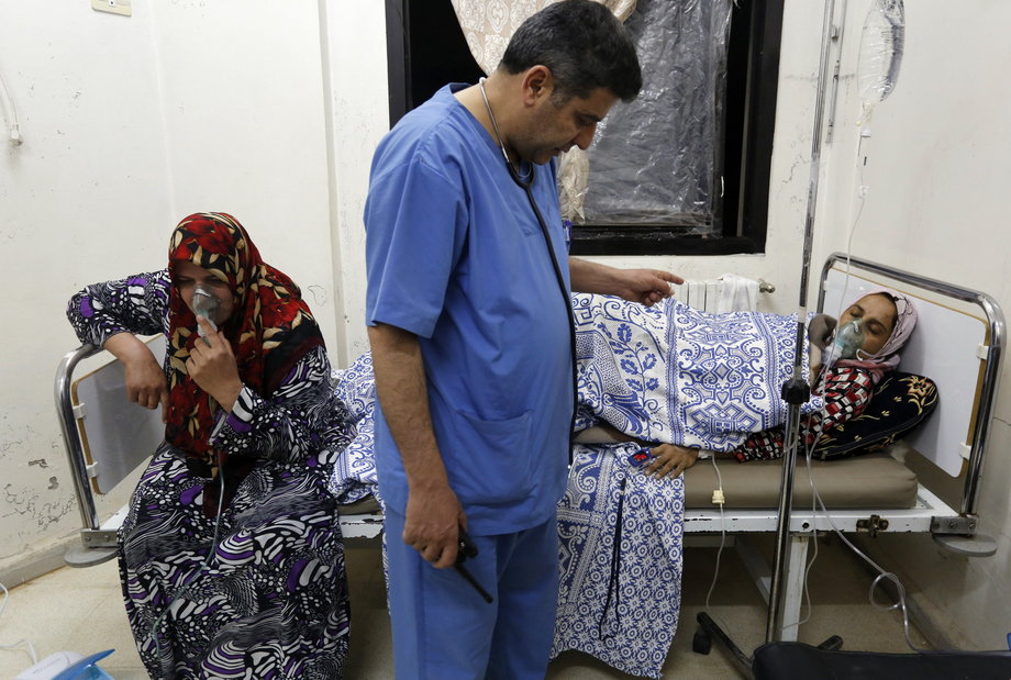 Women, affected by what activists say was a gas attack, receive treatment inside a makeshift hospital in Kfar Zeita village in the central province of Hama on May 22, 2014.