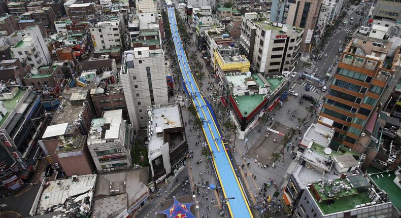 A 350-meter-long (1,148 feet) water slide seen during the 2015 City Silde Festa in central Seoul, South Korea.