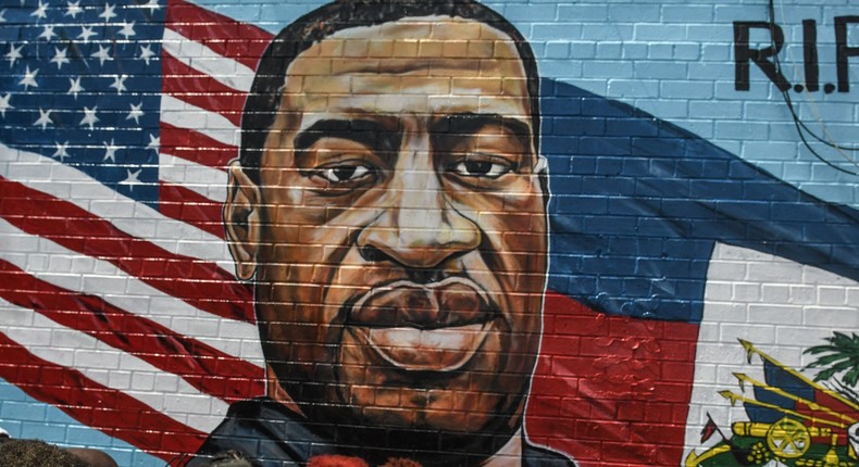 A mural painted by artist Kenny Altidor depicting George Floyd is unveiled on a sidewall of CTown Supermarket on July 13, 2020 in the Brooklyn borough New York City.