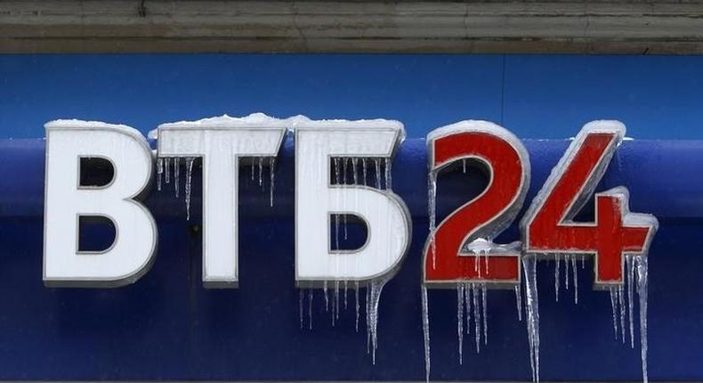 A sign displaying the logotype of VTB Bank, covered with icicles, is seen above the bank office in central Moscow, file. 