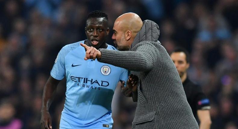 Manchester City manager Pep Guardiola gestures to Benjamin Mendy