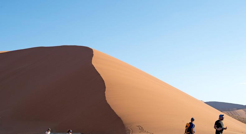 Tourists walk by a dune at Namib-Naukluft National Park.Xinhua News Agency/Getty Images