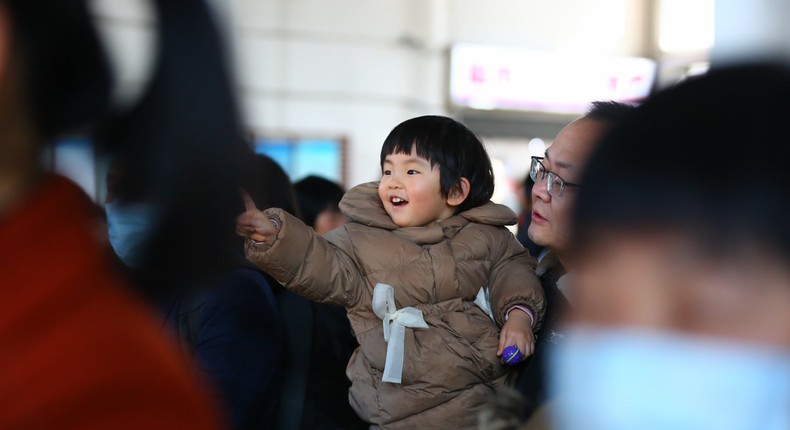 A child waits to get on a train at Tengzhou Railway Station in Tengzhou, east China's Shandong Province, Feb. 16, 2024.Li Zhijun/Xinhua via Getty Images