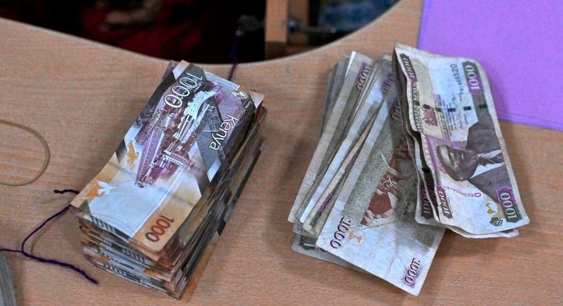 This picture taken on September 30, 2019 shows old and new-issue currency bills on a desk at a branch of a local bank in the Kenyan capital, Nairobi. (Photo by TONY KARUMBA/AFP via Getty Images)