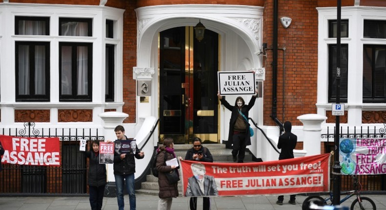 Supporters of WikiLeaks founder Julian Assange display banners and placards as they gather outside the Ecuadorian Embassy in London, where Assange has been living for more than six years and will meet with an independent rights expert