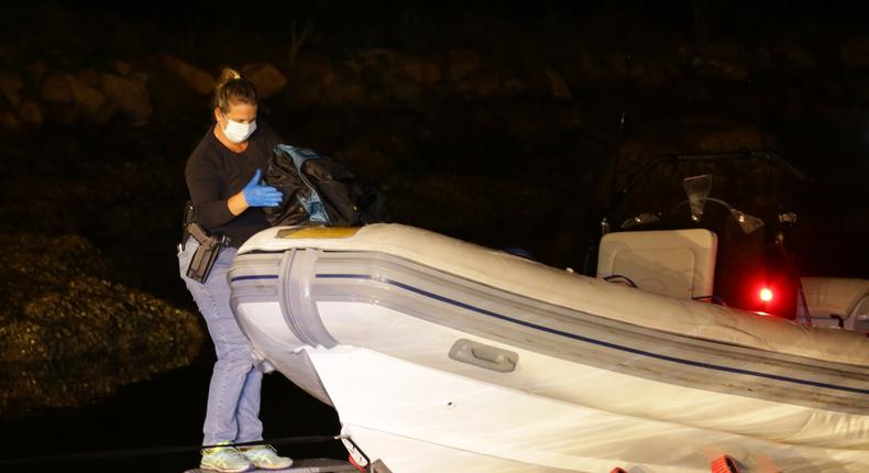 An Australian investigator unloads cargo from a seize boat, December 2016.