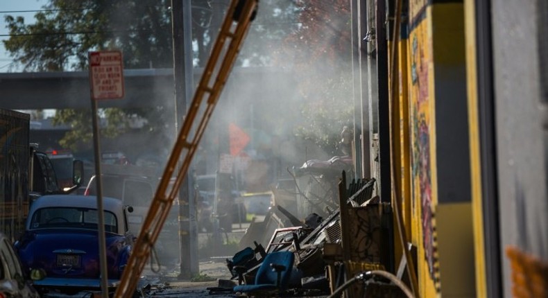 A warehouse smoulders after it was destroyed by a fire, December 3, 2016 in Oakland, California