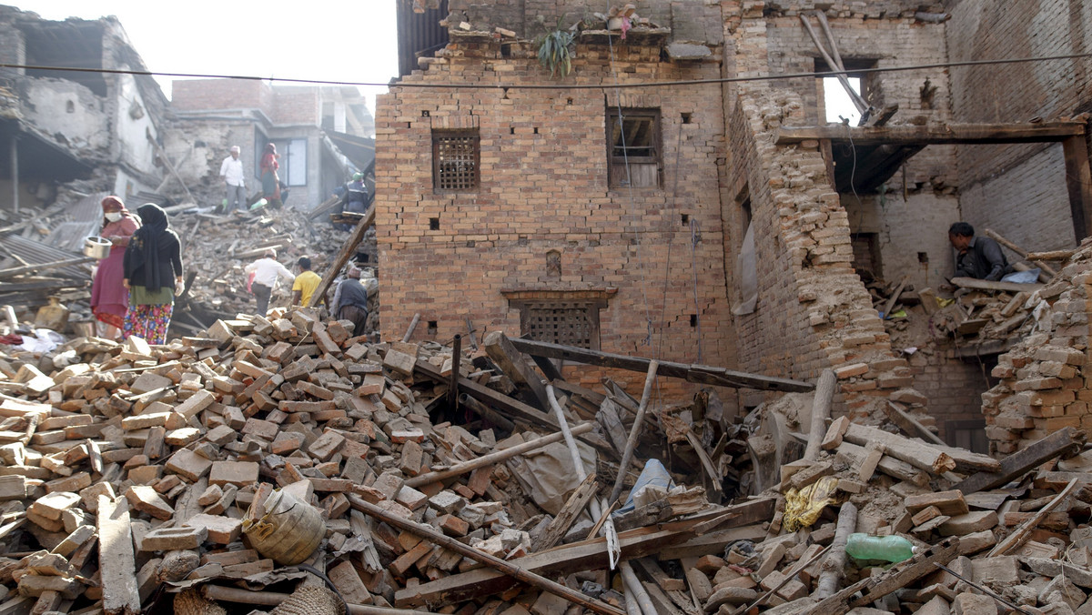 Local residents clear the rubble from their homes which were destroyed after last week's earthquake in Bhaktapur