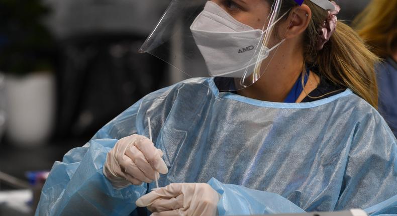 A health staff member prepares a COVID-19 test at the Histopath Diagnostic Specialists pre-departure area at Sydney International Airport on November 28, 2021.