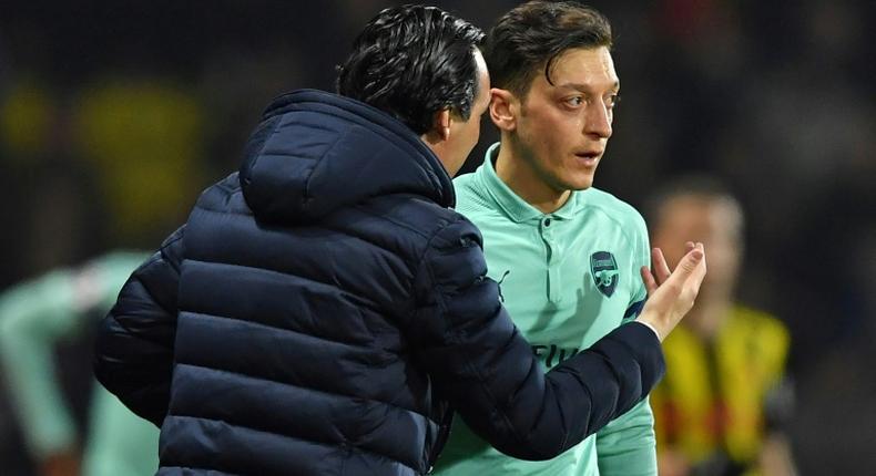 Mesut Ozil (right) is frustrated at his lack of game time under Arsenal manager Unai Emery