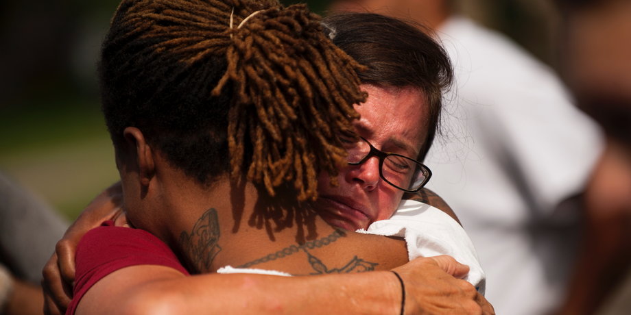 Two people embrace during a demonstration for Philando outside the Governor's Mansion following the police shooting death of a black man on July 7, 2016 in St. Paul, Minnesota.
