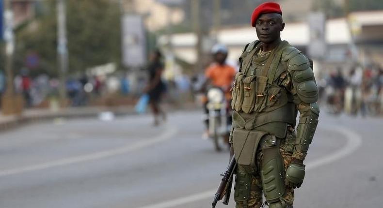 A soldier holds his weapon as he watches a procession by Uganda's leading opposition party Forum for Democratic Change supporters being dispersed in Kampala, Uganda, February 15, 2016. 