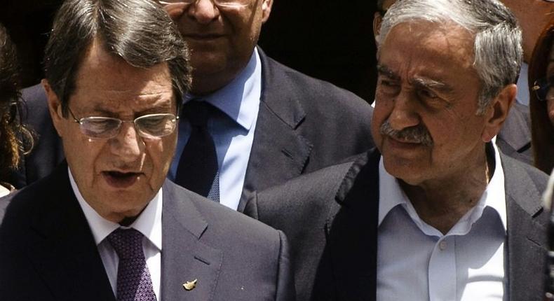 Greek Cypriot President Nicos Anastasiades (L) and Turkish Cypriot leader Mustafa Akinci, seen together during a social function in Nicosia's UN-patrolled buffer zone, in June 2016