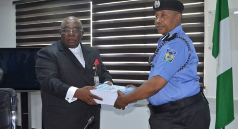 The chairman of the SIP, DIG Joseph Egbunike submitting panel report on Abba Kyari-Hushpuppi scandal to IGP, Usman Baba. (The Cable)