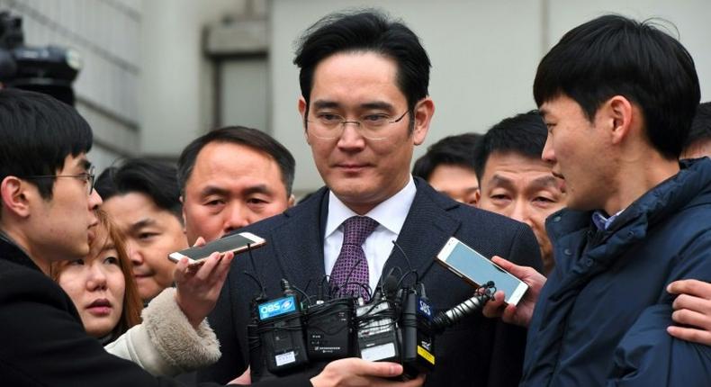 South Korean prosecutors accused Lee Jae-Yong (C), the heir to the Samsung business empire, of embezzling funds, committing perjury and playing a key role in a corruption scandal that led to the ouster of former President Park Geun-Hye