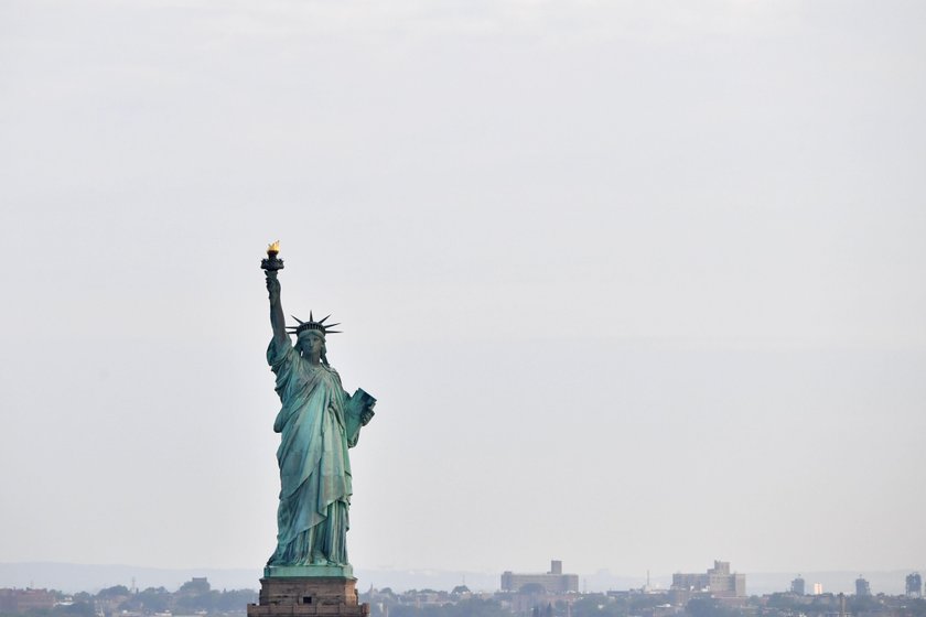 A sign announcing the closure of the Statue of Liberty, due to the U.S. government shutdown, sits ne