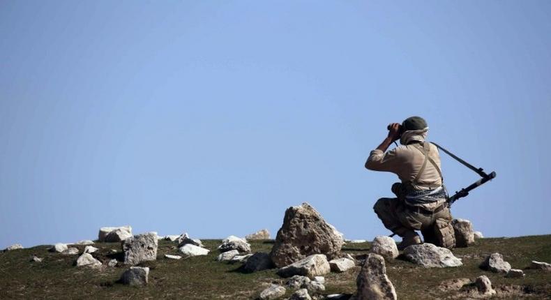 An Iraqi soldier watches enemy positions from Badush on March 9, 2017