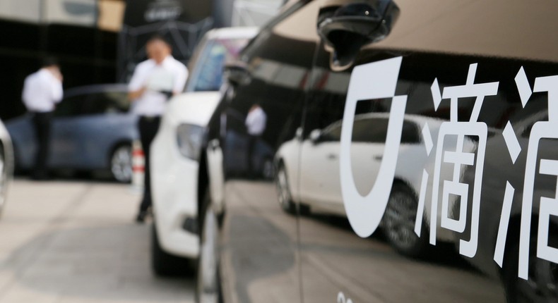 Didi sign is seen on a car during the China Internet Conference in Beijing.
