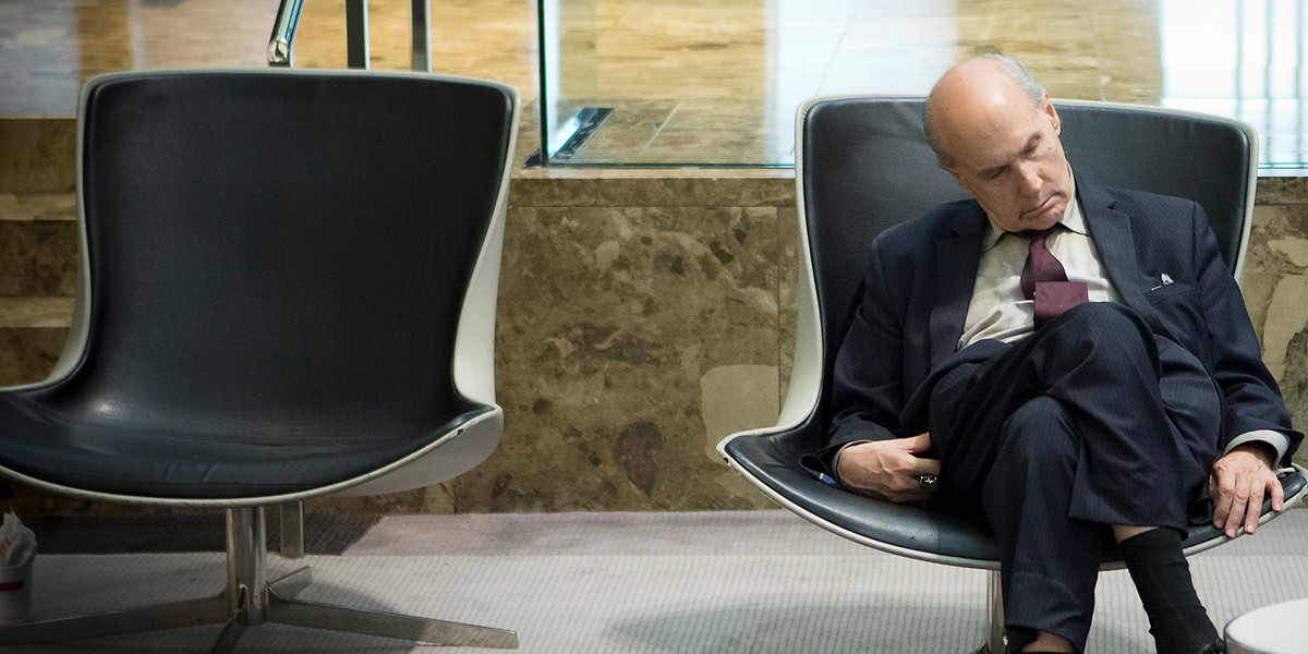 A businessman takes a mid-day nap in the lobby of a midtown hotel in the Manhattan borough of New York August 1, 2014.