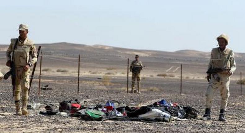 Egyptian army soldiers collect belongings of passengers from the crash site of a Russian airliner at the Hassana area in Arish city, north Egypt, November 1, 2015.