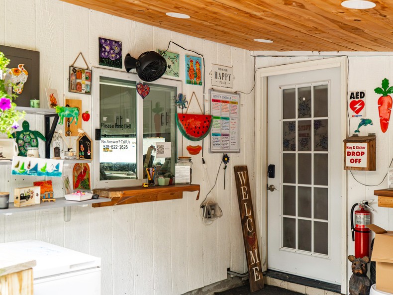 The check-in window was on the side porch of a large, white house at the front of the property. I found it modest and crafty, with art projects decorating the walls.Here, I received a bracelet that served as a key card for my booking.