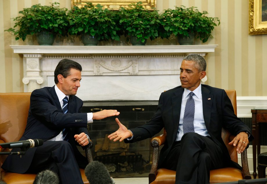 US President Barack Obama, right, shakes hands with Mexican President Enrique Peña Nieto during their meeting at the White House, January 6, 2015.